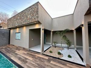 a house with a swimming pool in front of it at Casa ARUANÃ 6 SUITES in Aruanã