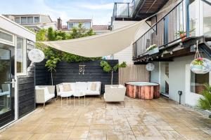 a patio with chairs and a table on a building at Chique Ibiza Zaandam in Zaandam