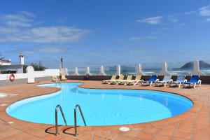 a swimming pool on the roof of a hotel at Almina in Corralejo