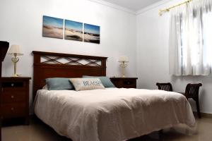 a bedroom with a bed and two chairs and a window at Almina in Corralejo +21 photos