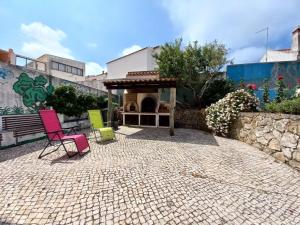 un grupo de sillas sentadas en un patio en Casa do Portão Azul - Espadarte, en Atouguia da Baleia