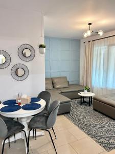 a living room with a couch and a table and chairs at EM House in Otopeni