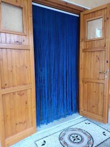 a room with two doors and a blue curtain at Beach House in Platamona