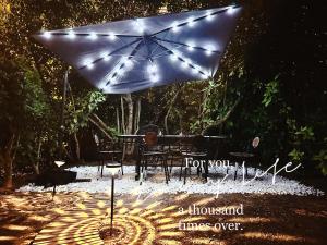 a table with an umbrella with lights on it at Paris maison-4min à Métro7-18min au centre de Paris in Villejuif