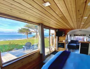 OphirThe Cape的一间卧室，里面有一张床和一扇大窗户。