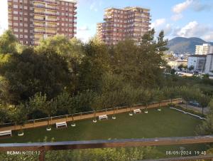 a park with benches and trees in a city at Coqueto apartamento con parking in Laredo