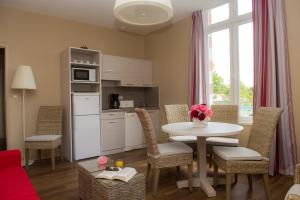 a kitchen and living room with a table and chairs at Résidence de Tourisme Vacances Bleues Villa Regina in Arcachon