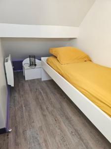 a bedroom with a bed and a wooden floor at Purple Baroque Rer C -N104-A6 in Brétigny-sur-Orge