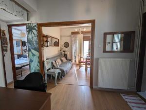 a living room with a couch and a table at Μπαλκόνι του Αιγαίου/ Aegean balcony in Tsagarada