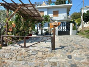 a sign on a stone patio in front of a house at Μπαλκόνι του Αιγαίου/ Aegean balcony in Tsagarada