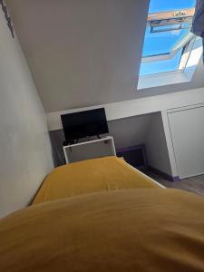 a bedroom with a bed and a desk with a computer at Purple Baroque Rer C -N104-A6 in Brétigny-sur-Orge