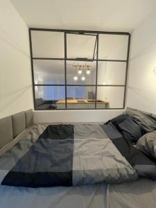 a bed in a room with a large window at zentrales Appartement zwischen Messe und Altstadt in Düsseldorf