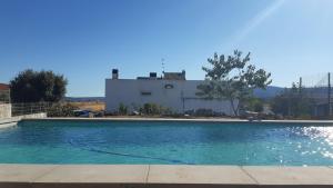 a swimming pool with a building in the background at Casa das Lagoas com piscina aquecida exclusiva in Bragança