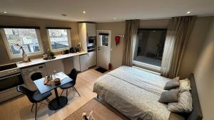 a bedroom with a bed and a table and chairs at Mysig studio lägenhet i Villa in Malmö