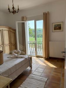 Postel nebo postele na pokoji v ubytování La Bastide des Launes près du Festival de Piano