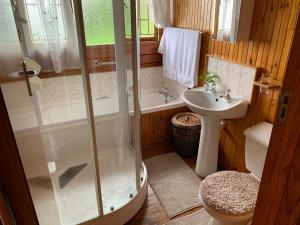 a bathroom with a shower and a sink at Bay View Cabin in Gordonʼs Bay +29 photos