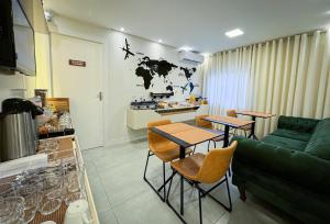 a living room with two tables and a green couch at Hotel São José in São José