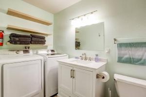 a bathroom with a washer and dryer and a sink at Cheyenne Chalet - Perfect little rancher in SLT! in Mevers +33 photos