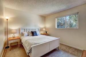a bedroom with a white bed and a window at Cheyenne Chalet - Perfect little rancher in SLT! in Mevers
