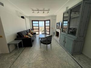 a living room with a couch and a table at Vista Cala del Pino in La Manga del Mar Menor