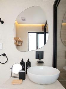 a bathroom with a large white tub and a mirror at Breathtaking house with patio in Roma Norte in Mexico City