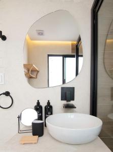 a bathroom with a large white tub and a mirror at Breathtaking house with patio in Roma Norte in Mexico City
