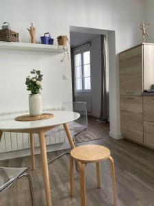 a table and two stools in a living room at MC Suite XL CMZ Gonzague Place-Ducale in Charleville-Mézières +12 photos