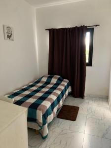 a bedroom with a bed in a room with a window at Angelina in Posadas +10 photos