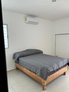 a bed in a white room with a mattressvisor at In Wotoch in Cancún +8 photos