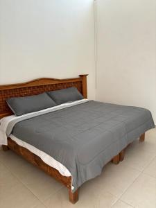 a bedroom with a large bed with a wooden headboard at In Wotoch in Cancún