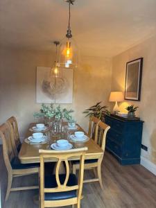 a dining room table with chairs and a dining room at Cozy 3-Bed Cottage with Hot Tub in Abergele