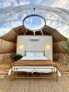 a bedroom with a bed in a tent at Draco at the Retreat in Fredericksburg