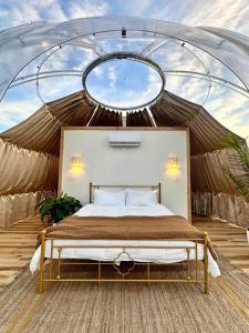 a bedroom with a bed in a tent at Draco at the Retreat in Fredericksburg +17 photos