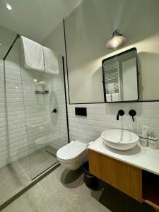 a bathroom with a toilet and a sink and a shower at Villa Ambassadori Kachreti Golf Resort in Gurjaani