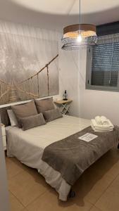 a bedroom with a large bed with a chandelier at blue house cordoba in Córdoba