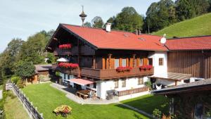 an aerial view of a house with a red roof at Appartement Oberschernthann in Hopfgarten im Brixental