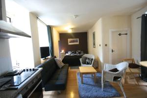 a living room with a couch and a table at Royal Mile Group Apartments in Edinburgh