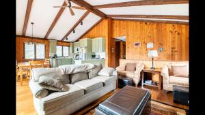 a living room with a couch and a kitchen at Beautiful Windham Chalet 2 minutes to the Mountain in Windham