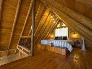 a room with two beds in a attic at Cabaña con Jacuzzi en Santa Elena in Medellín
