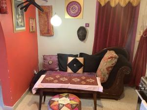 a living room with a couch and a table at sunrise flats in Mellieħa