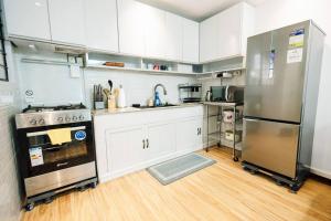 a kitchen with white cabinets and stainless steel appliances at Balikbayan hub in Cabanatuan in Cabanatuan +20 photos