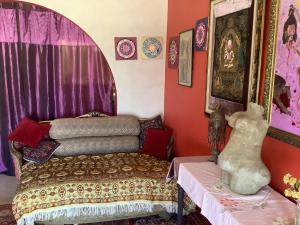 a room with a bed and some pictures on the wall at sunrise flats in Mellieħa