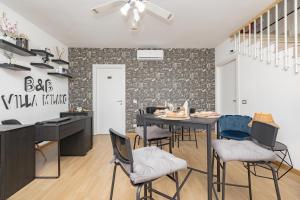 a kitchen and dining room with a table and chairs at B&B Villa Milano by Rhospitality it in Cornaredo
