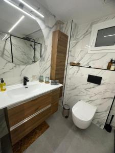 a bathroom with a white sink and a toilet at Vidanova 1 in Vilanova i la Geltrú +12 photos