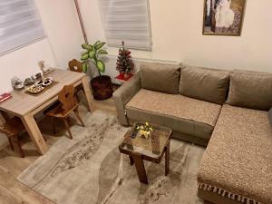 a living room with a couch and a table at Vila Vasilisa in Prijepolje +8 photos