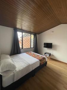 Cama o camas de una habitación en Bamuka Hostal