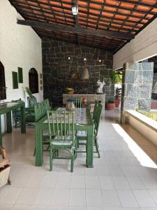 a green table and chairs on a patio at Ampla casa de 3 quartos com piscina em Serrambi PE a 50mts do mar in Porto De Galinhas +47 photos