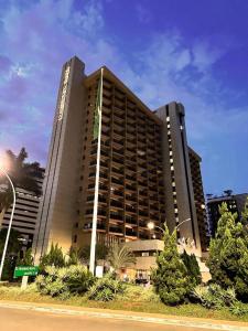 a large building with trees in front of it at Kubitschek Plaza Hotel - Flat Particular 4 - ALM Hospedagens in Brasília