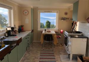 a kitchen with a small table and a window at Cozy small house with amazing view in Hennes