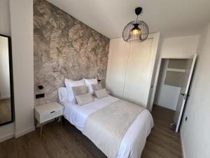 a bedroom with a bed and a wall mural at Casa Lupita in El Cotillo